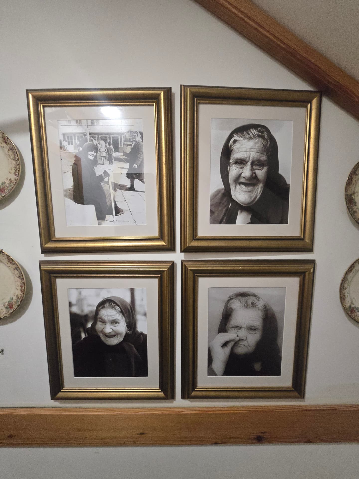 Four framed portraits of cloaked women at Tasca das Tias.