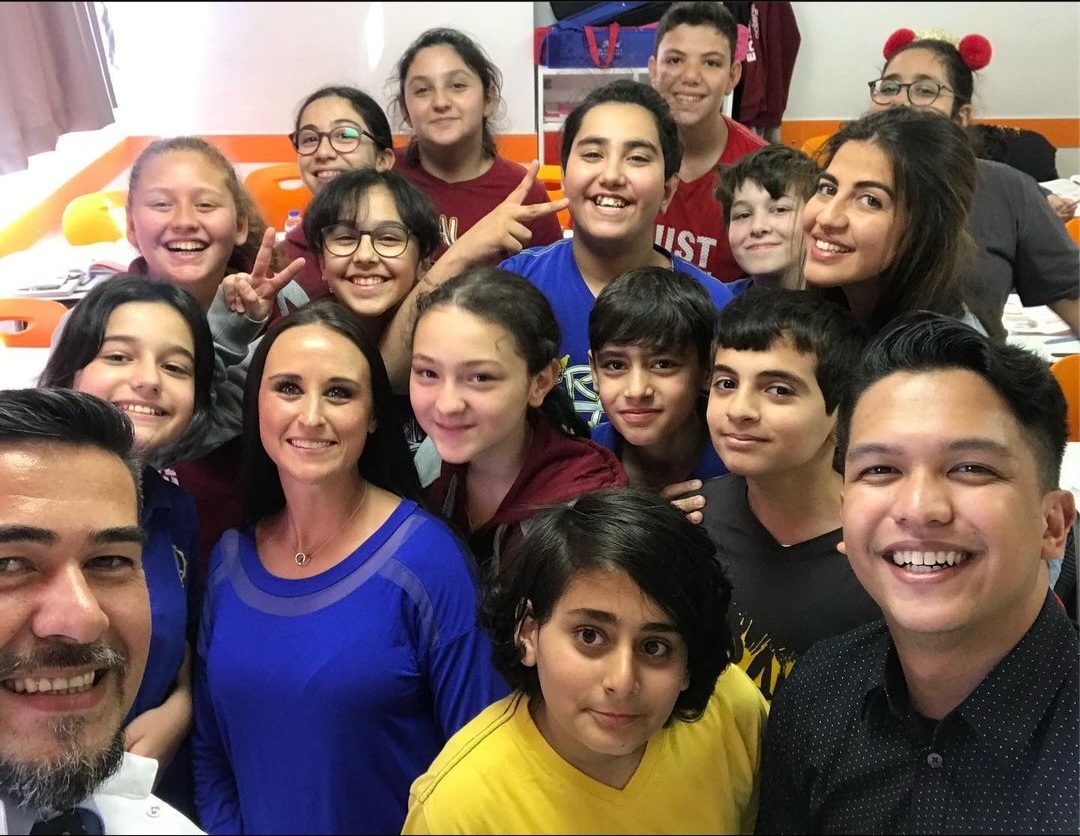 Nikki in a classroom selfie with students in Turkey.