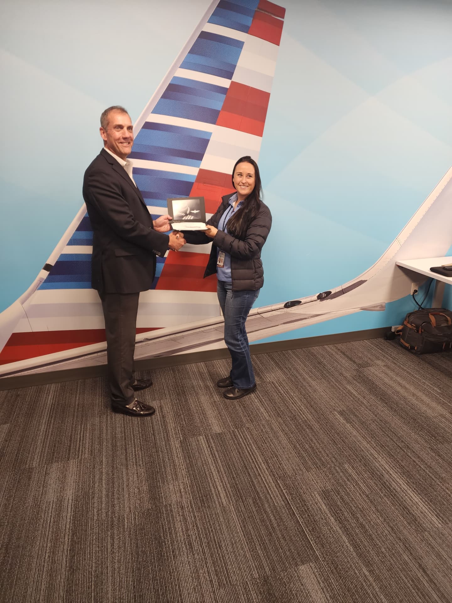 Nikki receiving her captain wings at American.