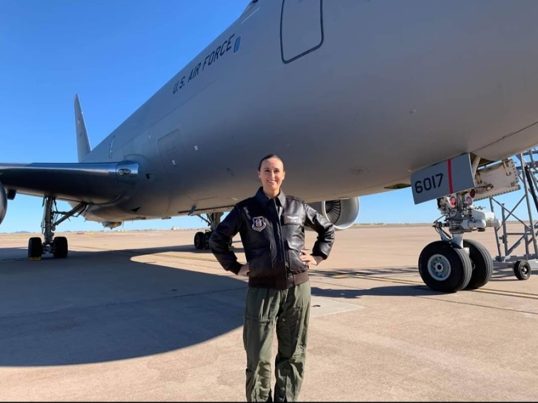 Nikki in her leather flight jacket beneath KC-46 tail number 6017.