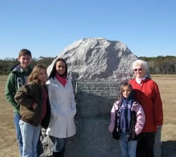 Nikki and family at the First Flight boulder at Kitty Hawk.