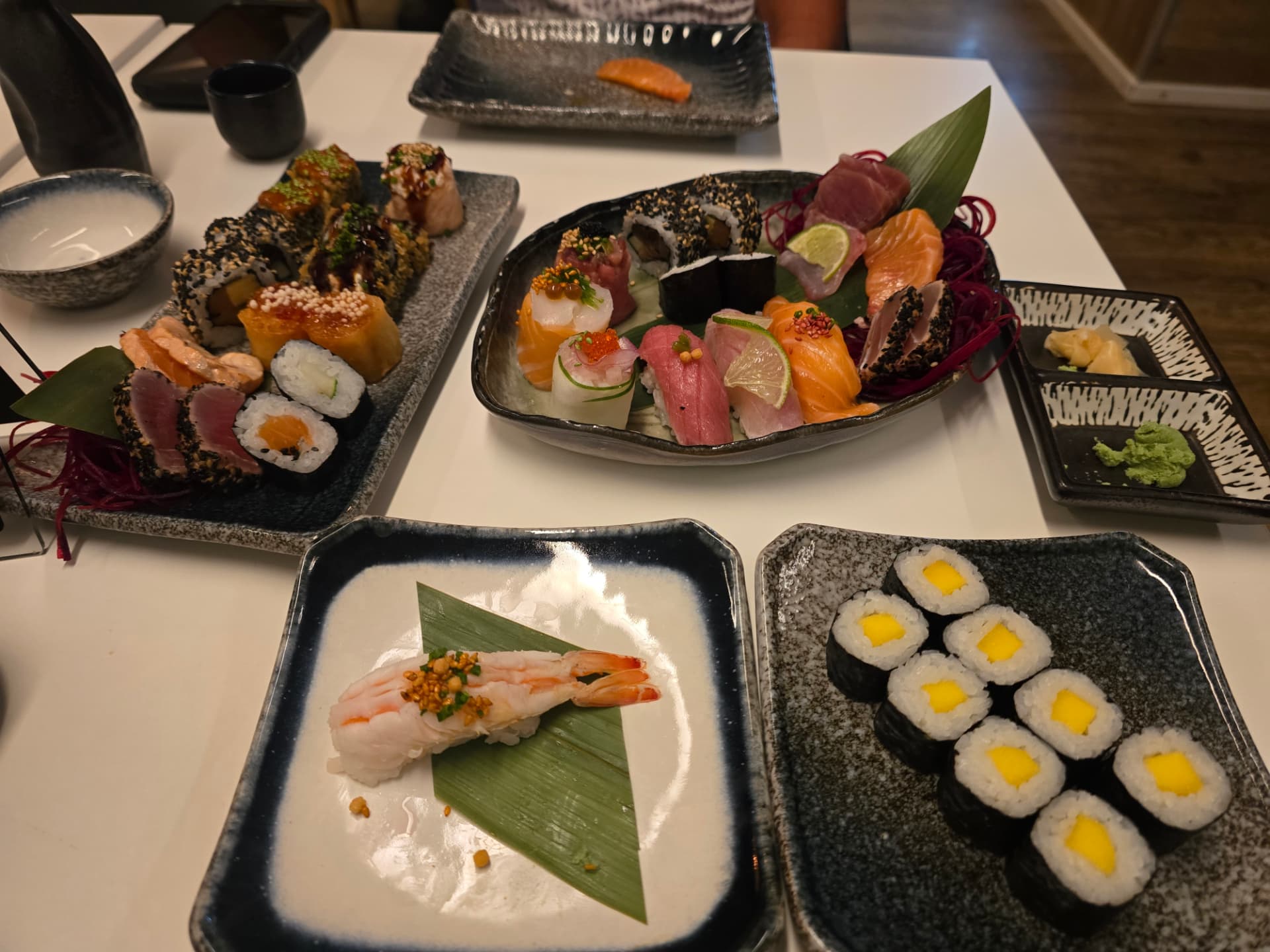 A table full of sushi platters.