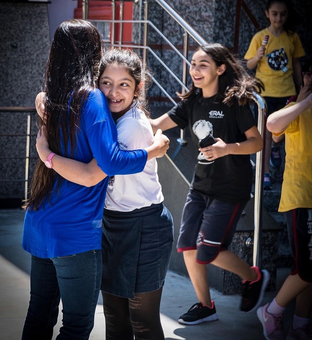 Nikki hugging a smiling student in Turkey.