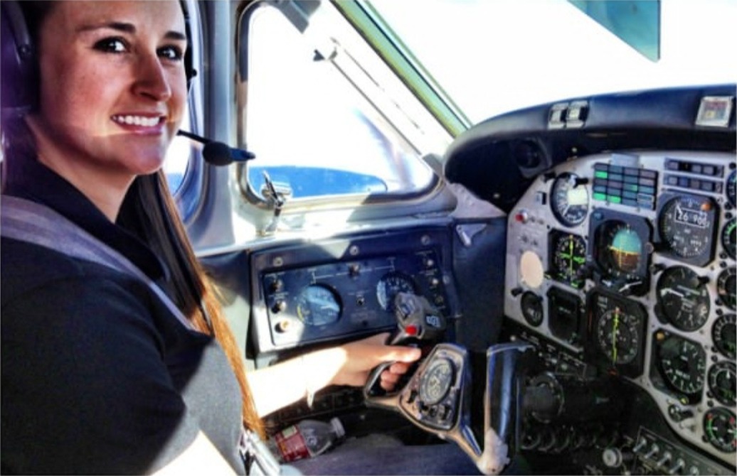 Nikki smiling at the controls of a King Air.