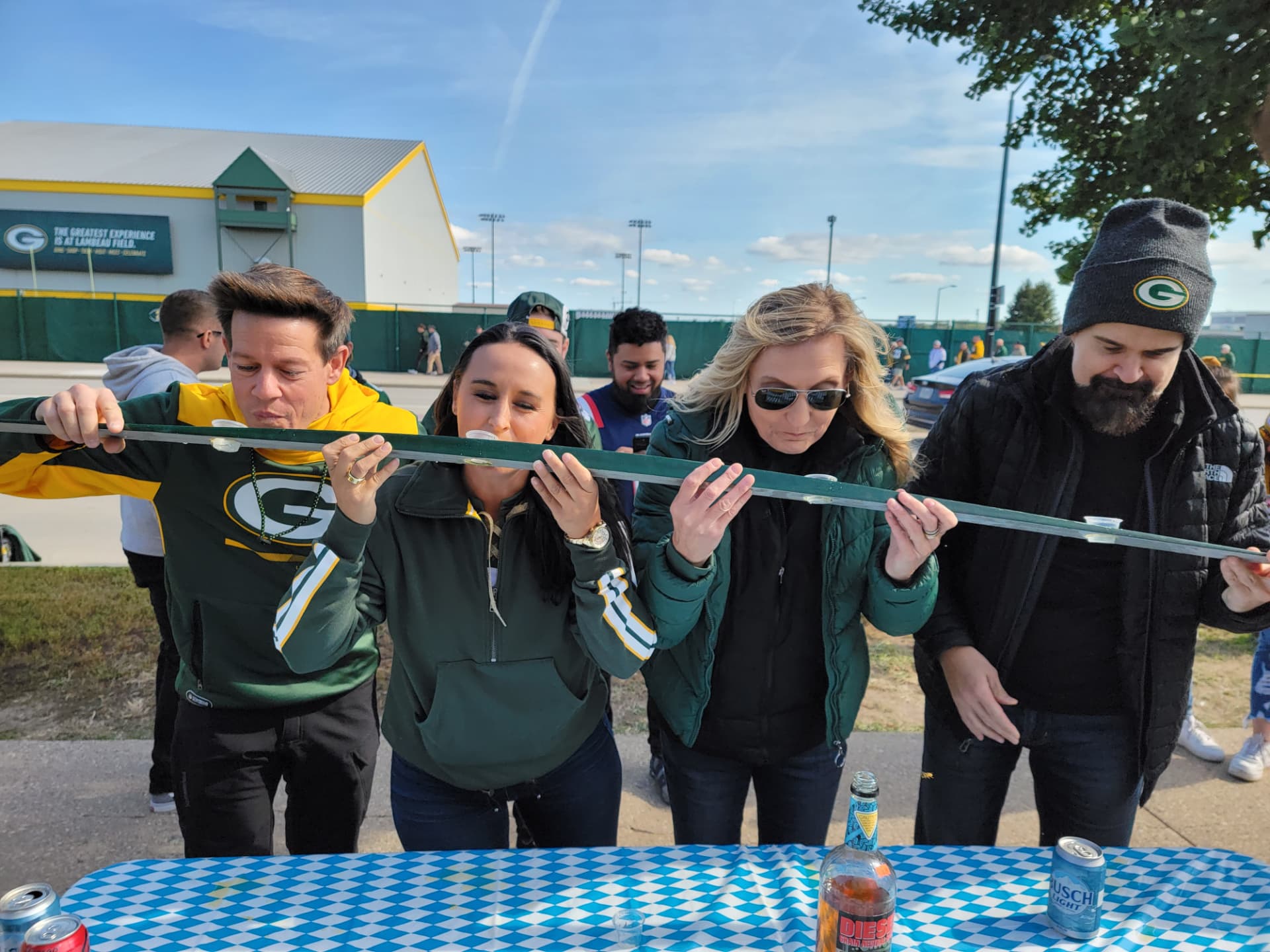 Nikki Bodie and friends taking a shot-ski together at a Green Bay Packers tailgate outside Lambeau Field.