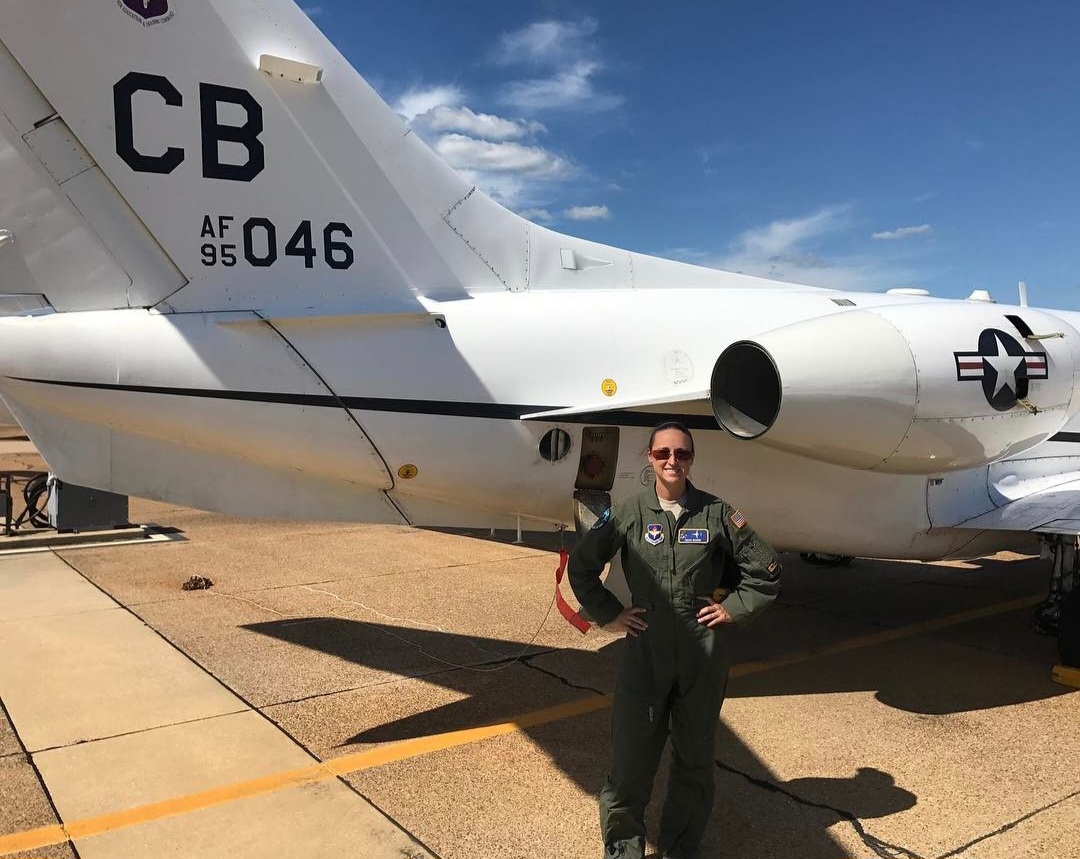 Nikki in her flight suit by the tail of T-1 CB 95-046.