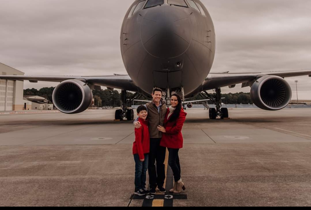 Nikki with her family in front of a KC-46.
