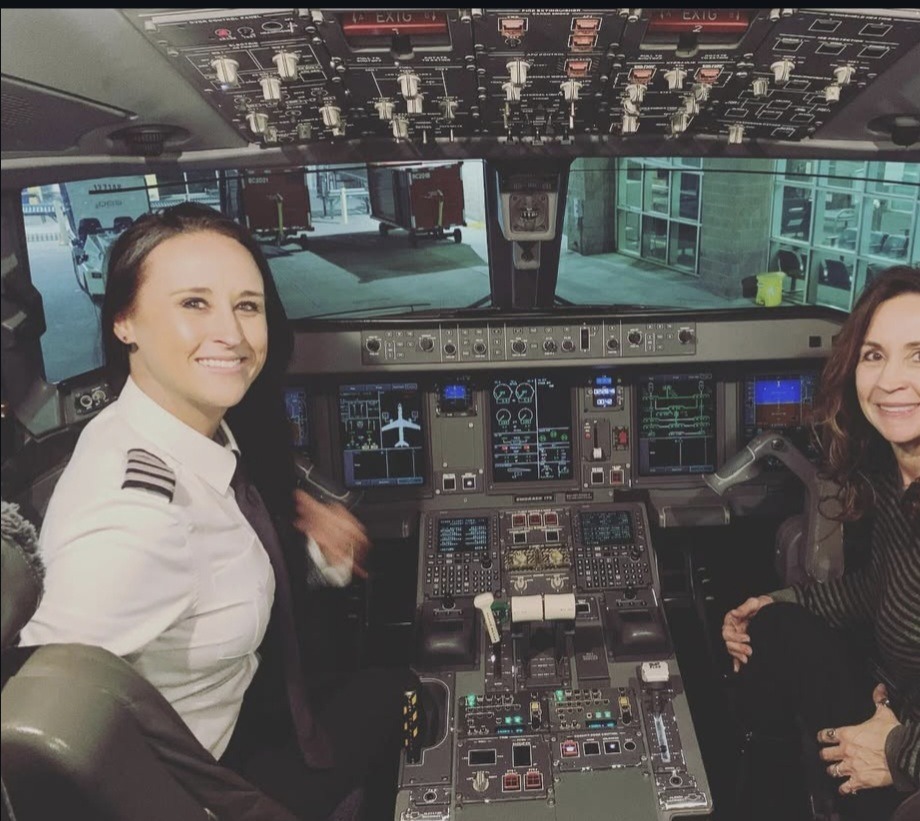Nikki in uniform with her mom Patti in the Embraer cockpit.
