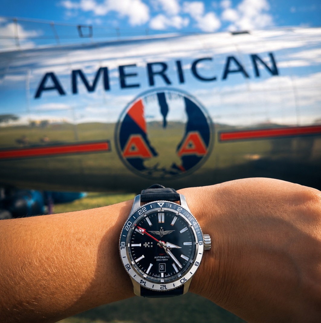 Nikki's watch against a vintage American Airlines airplane.