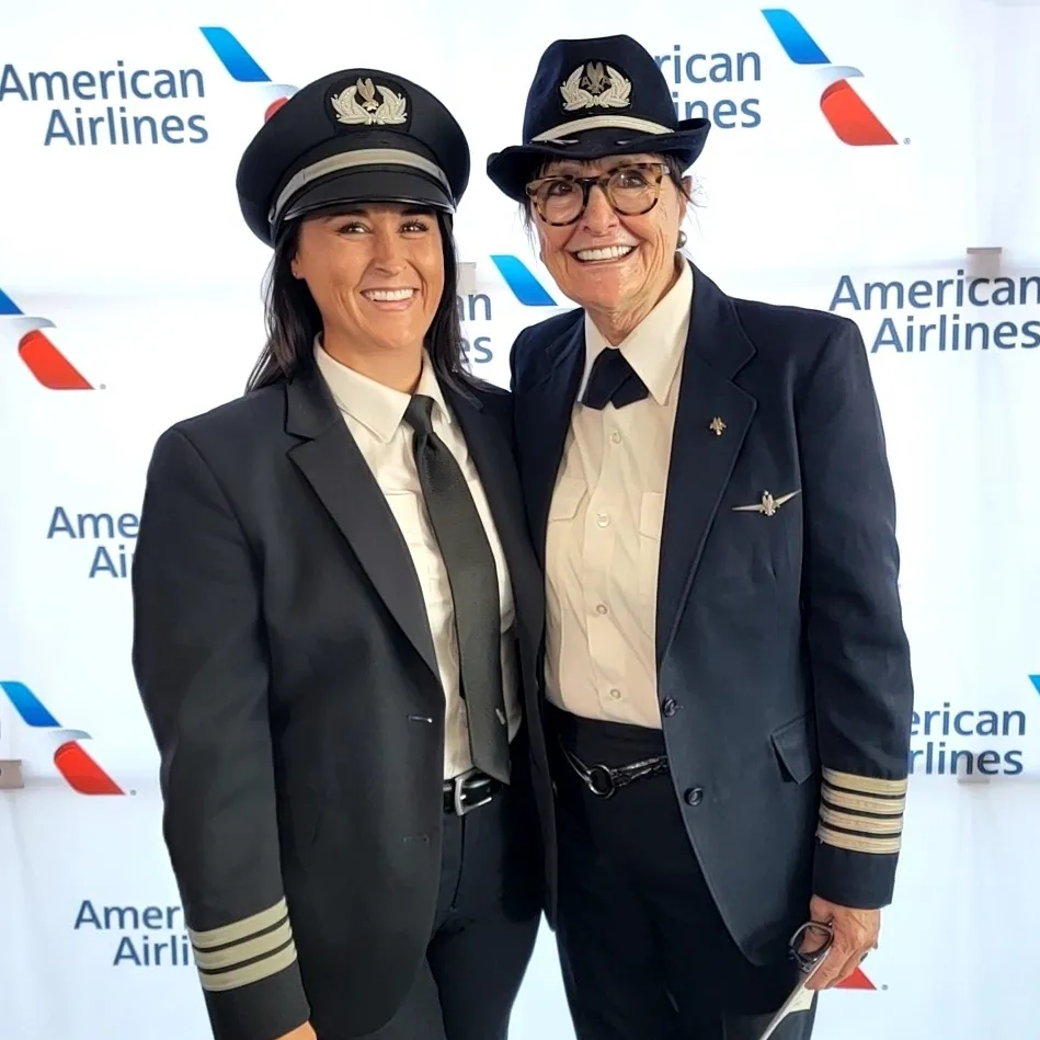 Nikki and Bonnie Tiburzi smiling together in American Airlines uniforms.