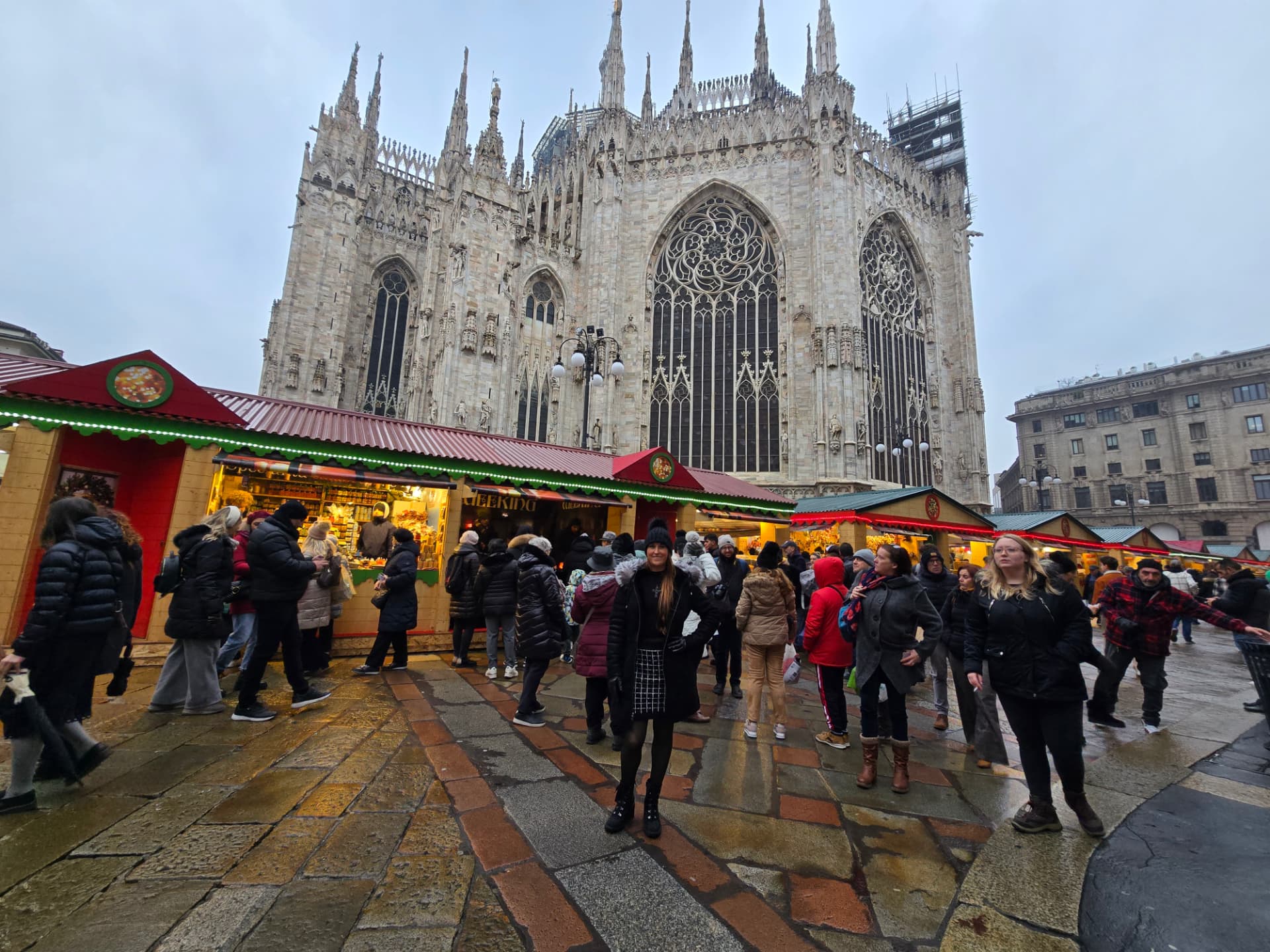 Nikki Bodie at the Christmas market stalls in front of the Duomo di Milano on a grey December day.