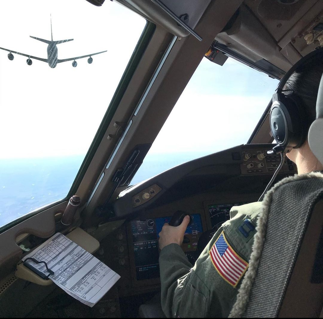 Nikki at the controls behind a tanker ahead in formation.