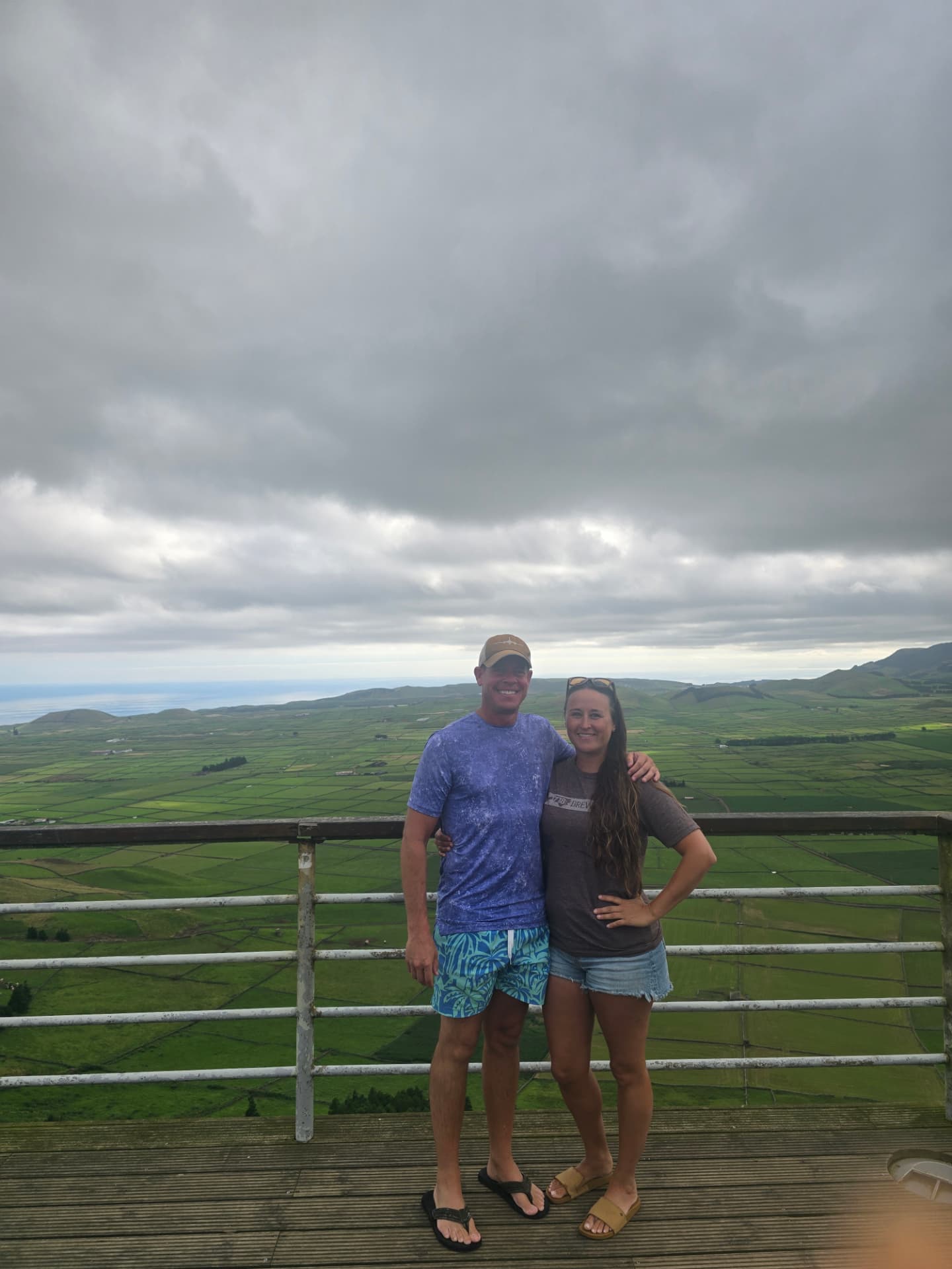 Nikki and Q at a lookout above patchwork fields.