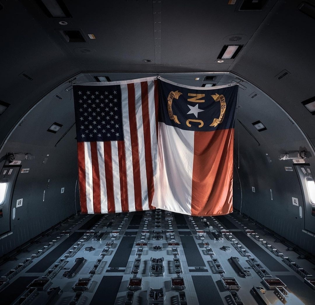 The American and North Carolina flags hanging in an empty tanker cargo hold.