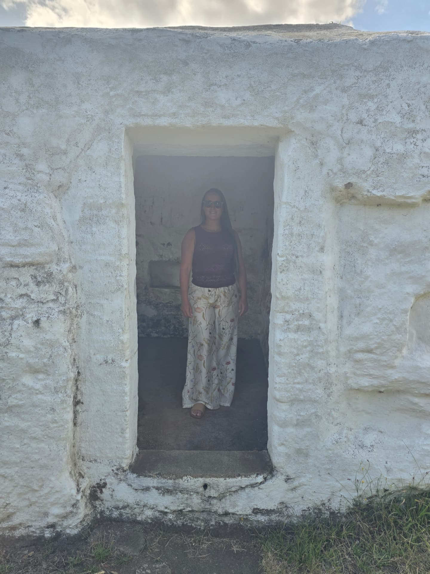 Nikki stepping forward through a white doorway.