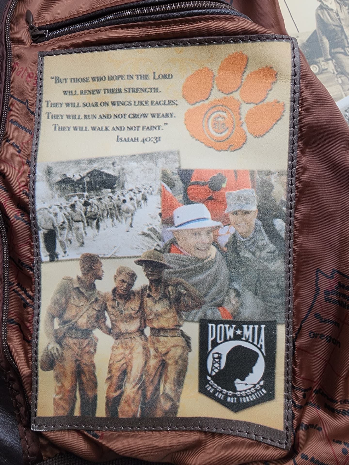 A jacket lining panel with Isaiah 40:31, the Clemson paw, and the POW-MIA emblem.