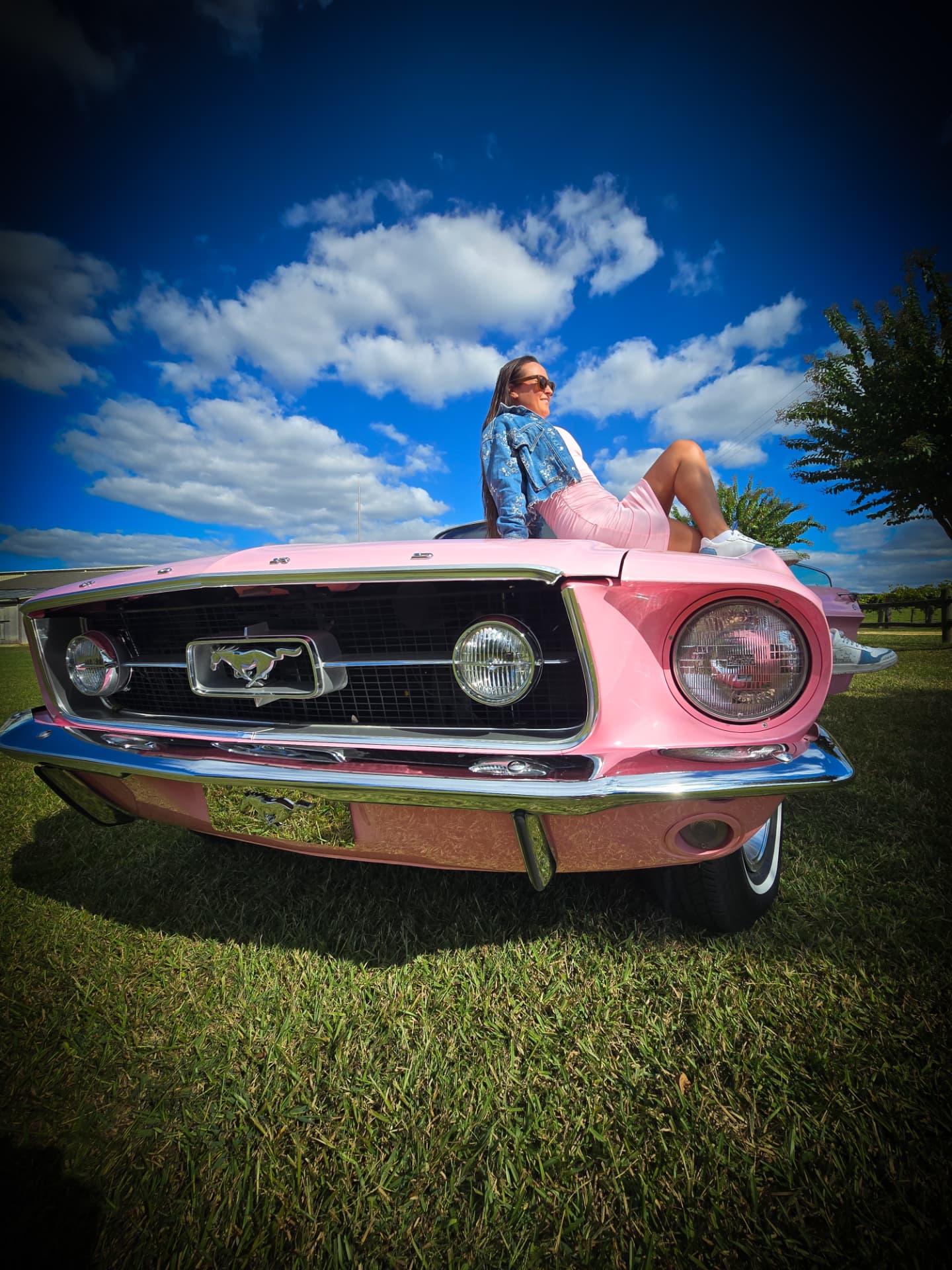 Nikki Bodie sitting on Reba Lou's pink hood.