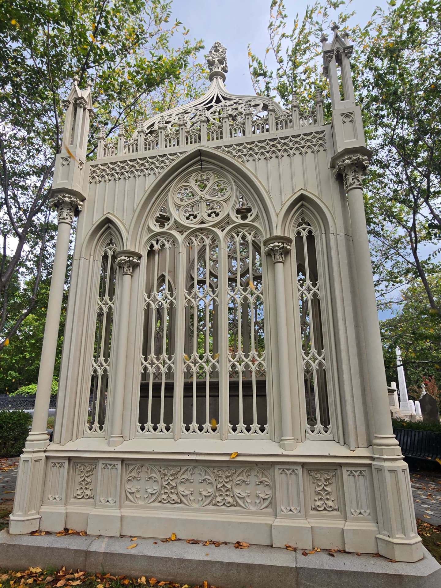 The Birdcage: an ornate pale Gothic Revival cast-iron mausoleum canopy with pointed arches and tracery, in Hollywood Cemetery.